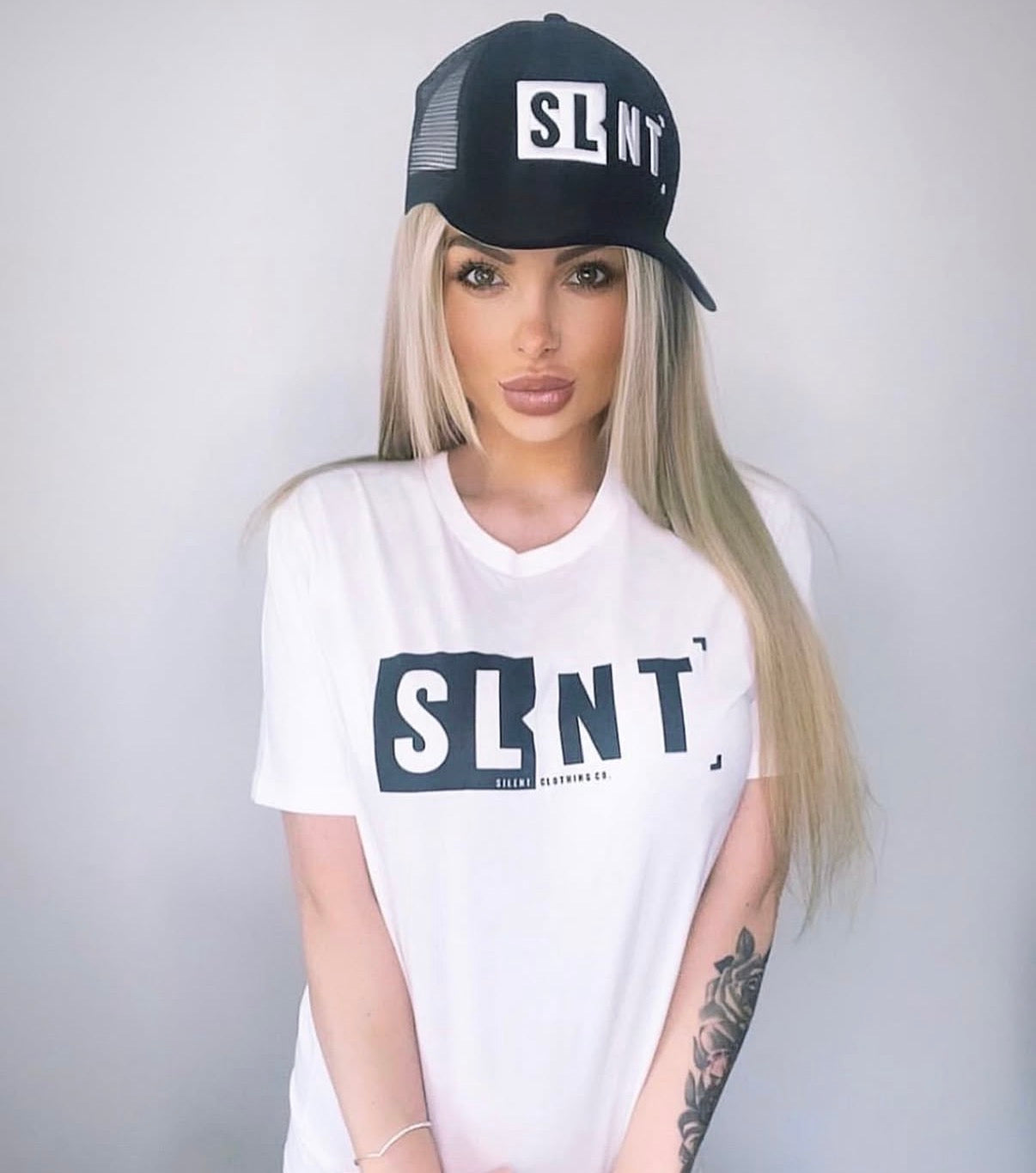 White SLNT logo T-shirt styled with a black SLNT cap